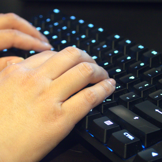 Decorative Image of hands typing on a keyboard